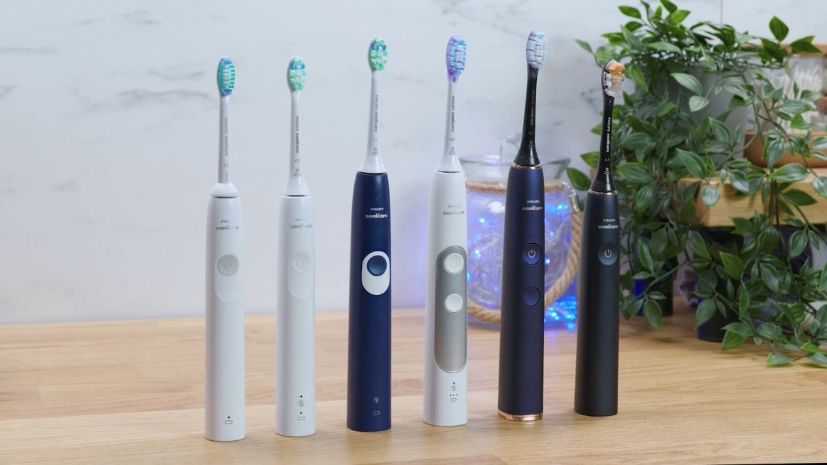 A line up of Sonicare electric toothbrushes stood next to each other.